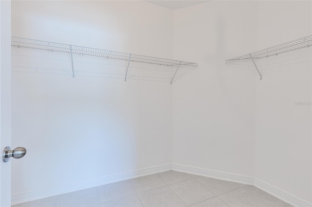 spacious closet featuring light tile patterned floors