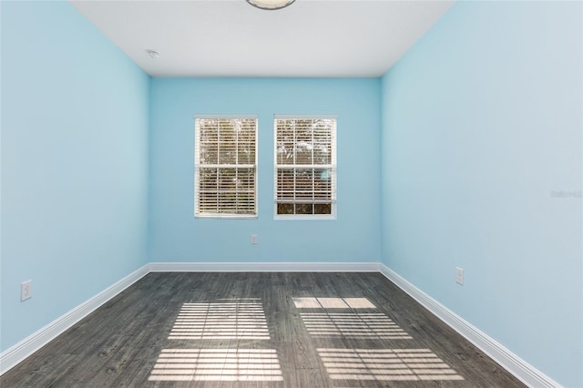 spare room featuring dark hardwood / wood-style flooring