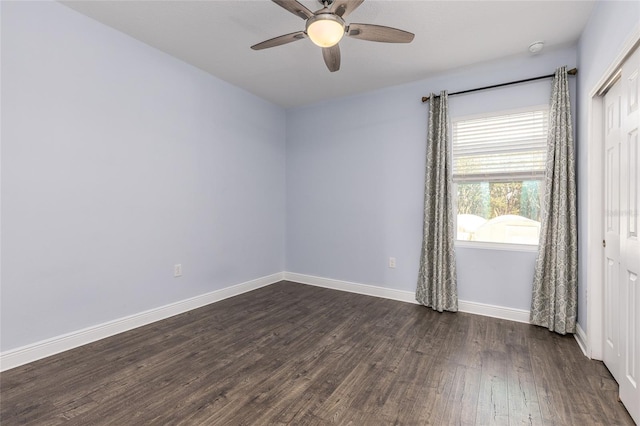 spare room with ceiling fan and dark hardwood / wood-style floors