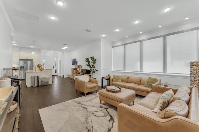 living room with dark hardwood / wood-style flooring and ornamental molding