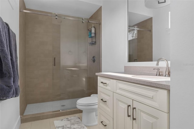 bathroom featuring tile patterned floors, vanity, toilet, and an enclosed shower