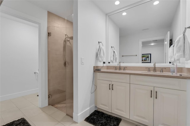 bathroom featuring tile patterned floors, vanity, and a shower with door