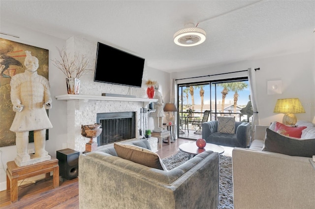 living room with hardwood / wood-style floors and a textured ceiling