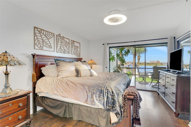 bedroom with access to outside and dark wood-type flooring