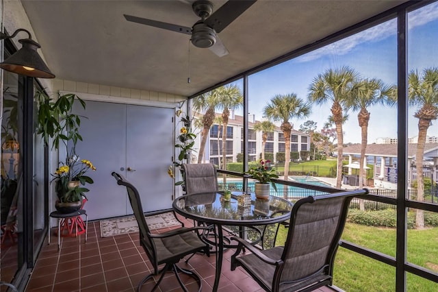 sunroom / solarium featuring ceiling fan