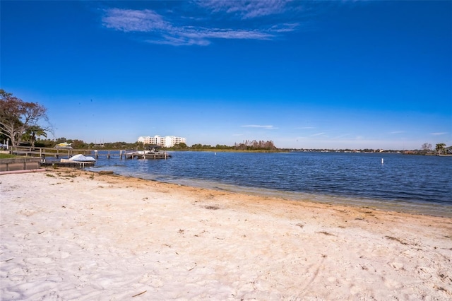 water view with a beach view and a boat dock