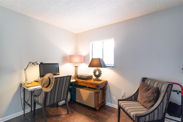 home office with a textured ceiling, baseboards, and wood finished floors