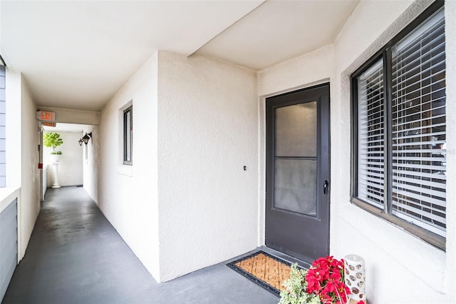 doorway to property with stucco siding