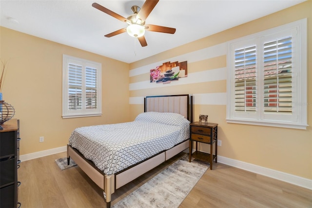 bedroom with light hardwood / wood-style flooring and ceiling fan