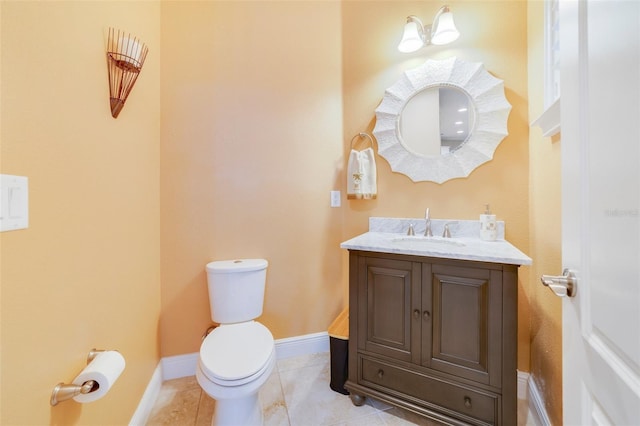 bathroom featuring vanity, tile patterned flooring, and toilet