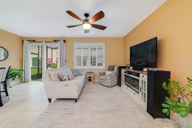 living room with light tile patterned floors and ceiling fan