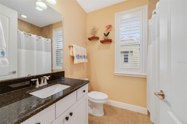 bathroom featuring toilet, tile patterned floors, and vanity