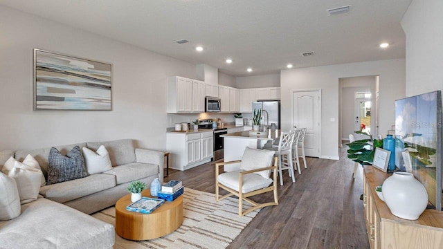 living room with dark hardwood / wood-style flooring