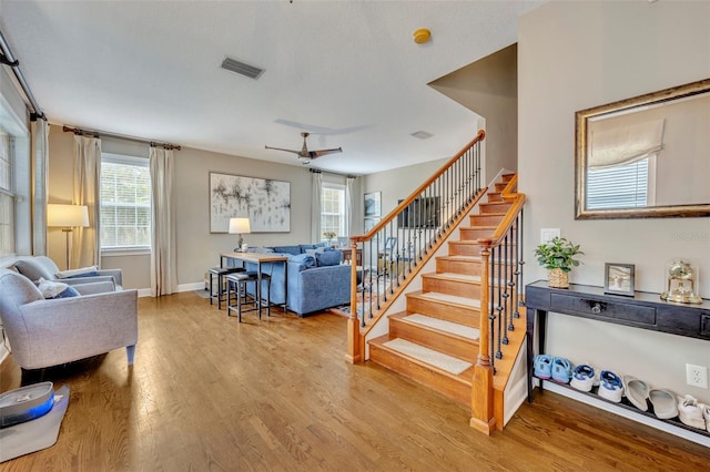 living room with hardwood / wood-style flooring and ceiling fan