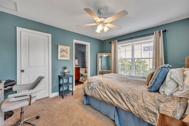 carpeted bedroom with ceiling fan and ensuite bathroom