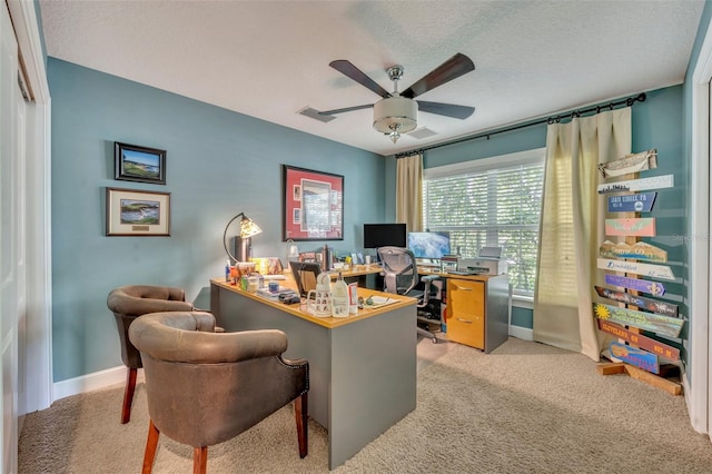 carpeted office with ceiling fan and a textured ceiling