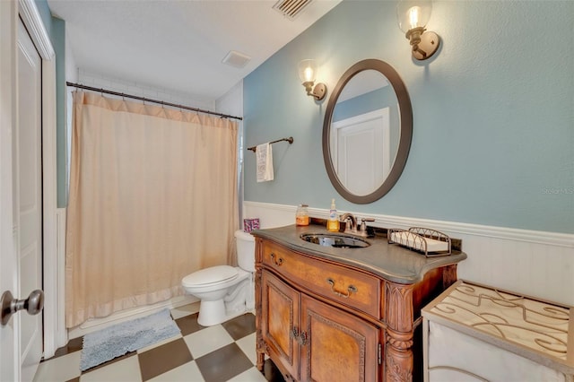 bathroom with vanity, toilet, and curtained shower