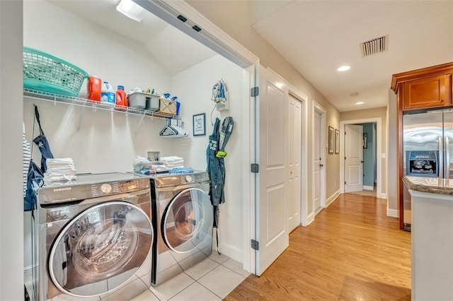 laundry room with light hardwood / wood-style floors and separate washer and dryer