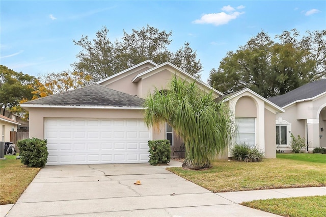 view of front of house featuring a garage and a front lawn