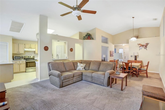 carpeted living room featuring vaulted ceiling and ceiling fan