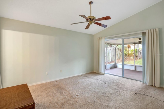 empty room with lofted ceiling, light colored carpet, and ceiling fan