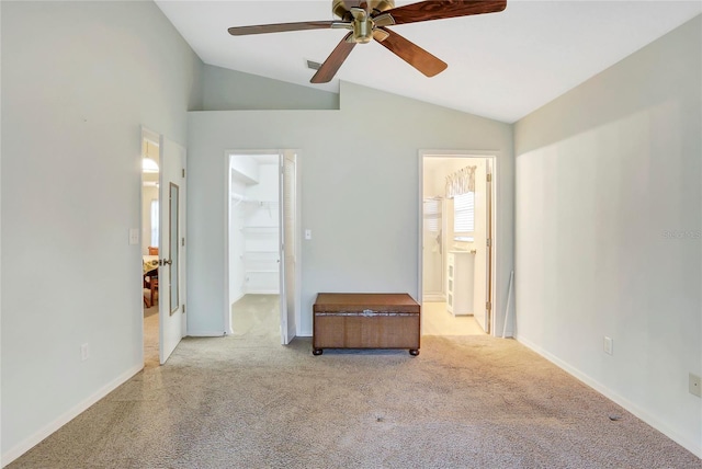 unfurnished room featuring light carpet, lofted ceiling, and ceiling fan