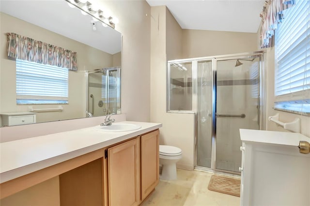 bathroom with vanity, toilet, and a shower with shower door