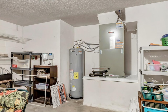 utility room featuring heating unit and electric water heater