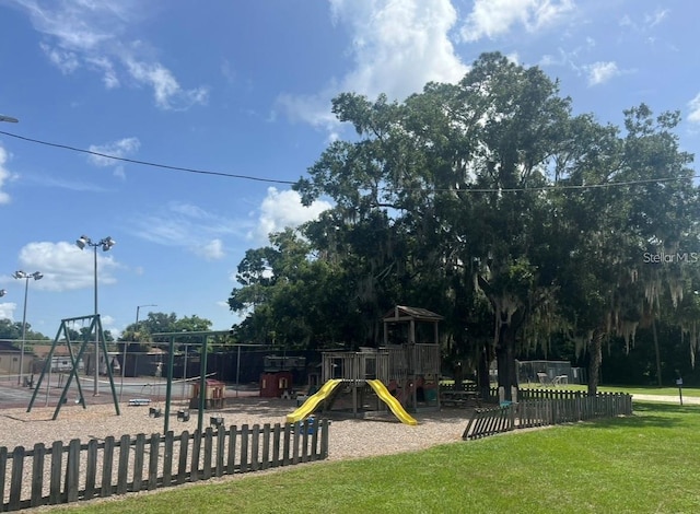 view of playground with a lawn