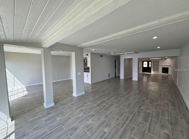 unfurnished living room with a textured ceiling and a fireplace