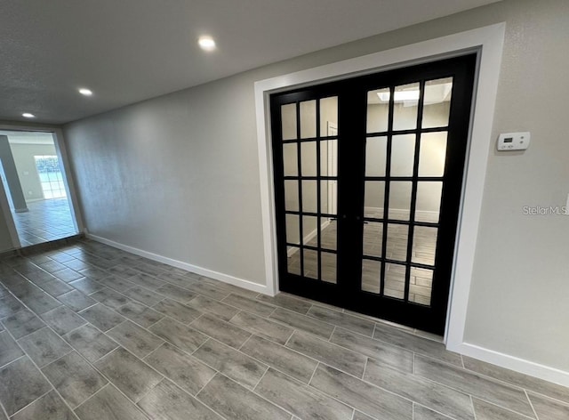 spare room featuring french doors