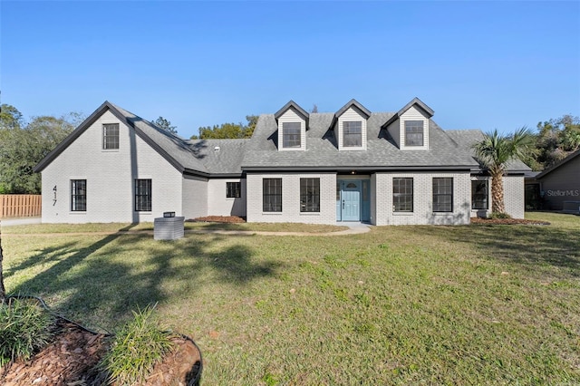 cape cod home featuring a front lawn