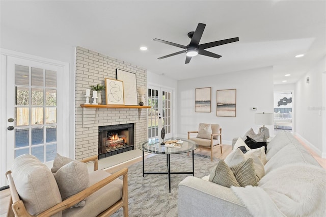 living room with a brick fireplace and ceiling fan