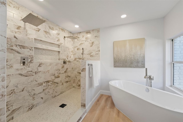 bathroom with independent shower and bath and hardwood / wood-style flooring