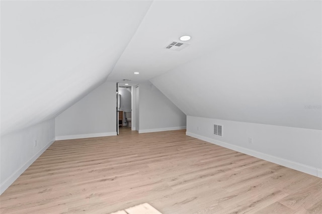 additional living space with lofted ceiling and light wood-type flooring