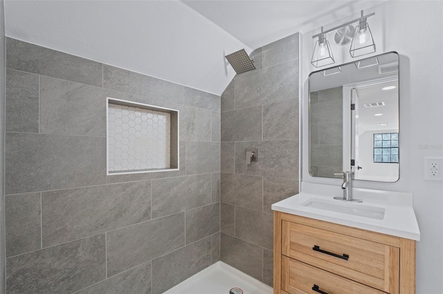 bathroom featuring vanity and tiled shower