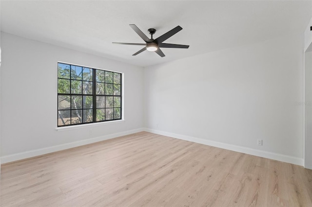 empty room with ceiling fan and light hardwood / wood-style flooring