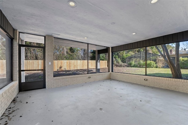 unfurnished sunroom featuring plenty of natural light