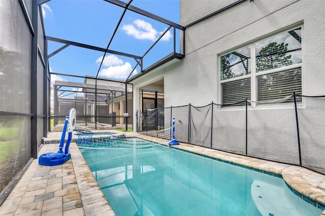 view of swimming pool featuring glass enclosure and an in ground hot tub