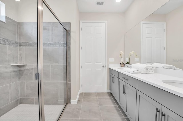 bathroom featuring vanity, tile patterned floors, and a shower with door