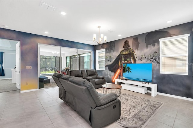 living room with a healthy amount of sunlight, light tile patterned floors, and a notable chandelier