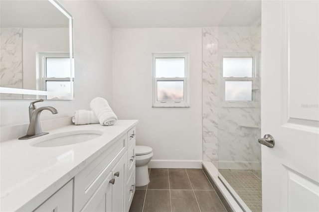 bathroom with plenty of natural light, toilet, a tile shower, and vanity