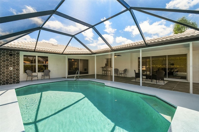 view of pool featuring a lanai, a patio area, and ceiling fan