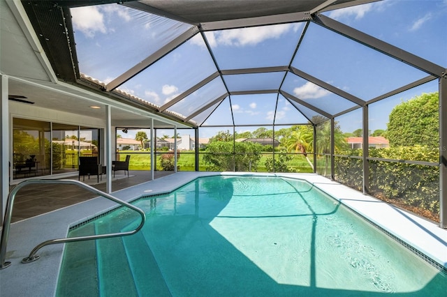 view of swimming pool featuring a lanai and a patio