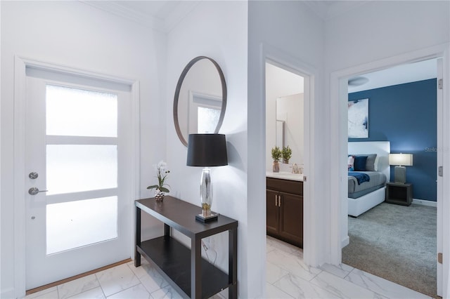 entryway with crown molding, sink, and light carpet