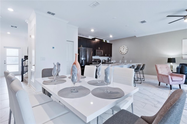 dining room featuring ceiling fan and ornamental molding