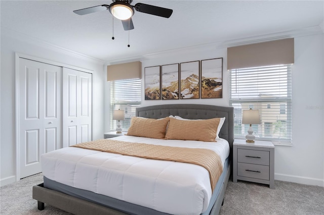 bedroom with light carpet, a closet, ceiling fan, and crown molding