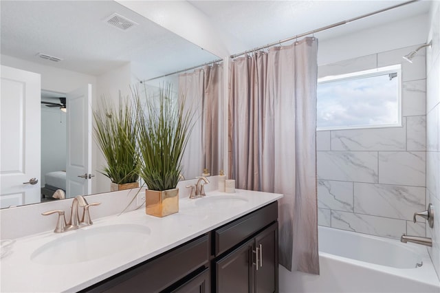 bathroom featuring vanity, ceiling fan, and shower / bath combo with shower curtain