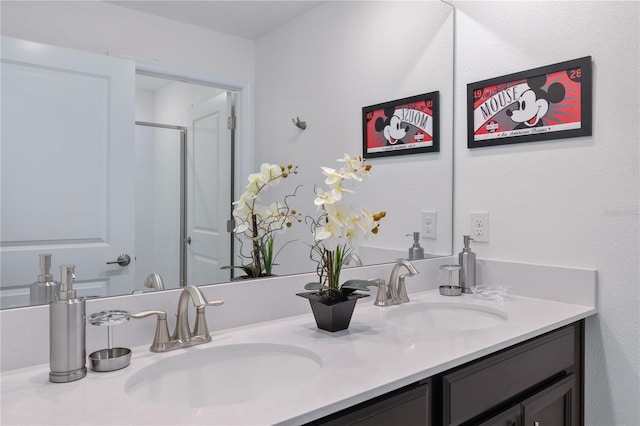 bathroom featuring a shower with door and vanity