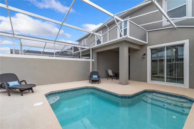 view of pool with a patio area and a lanai